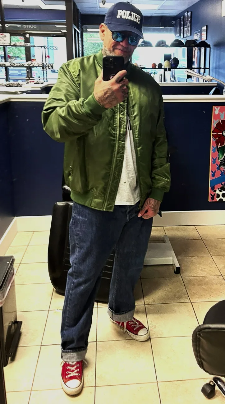 Host in a green jacket and red sneakers