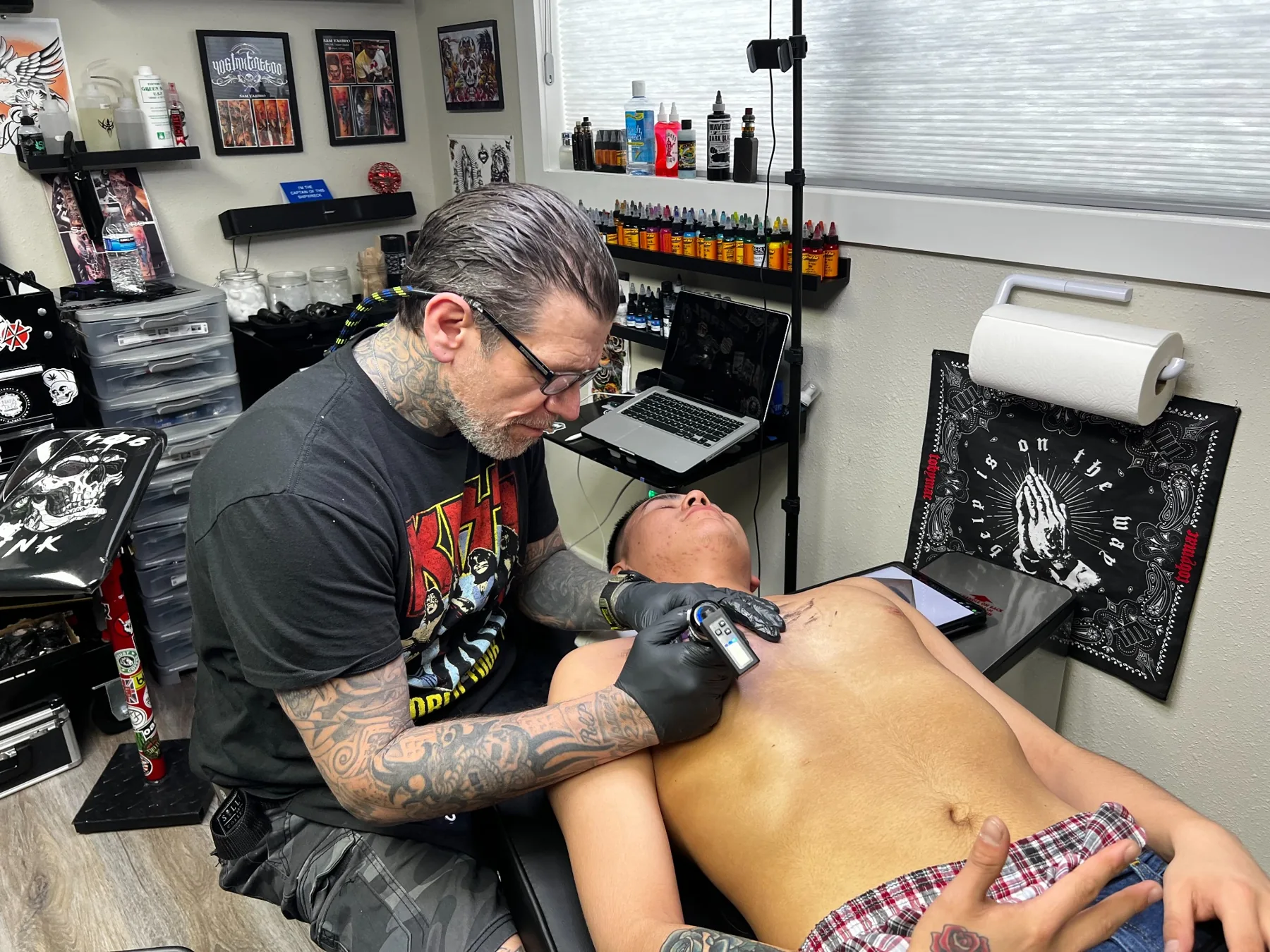 Tattoo artist at work in a professional studio