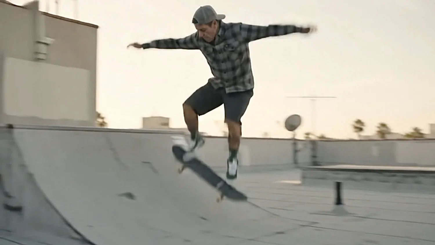 Skateboarder performing an aerial trick at a skatepark
